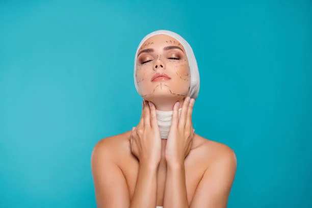Woman with facial bandages on blue background